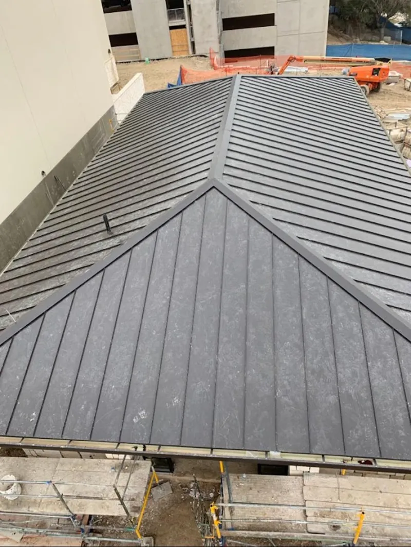 Commercial metal roof construction with crane equipment in Bluffton